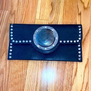 Small black clutch purse. By Carlos Falchi.